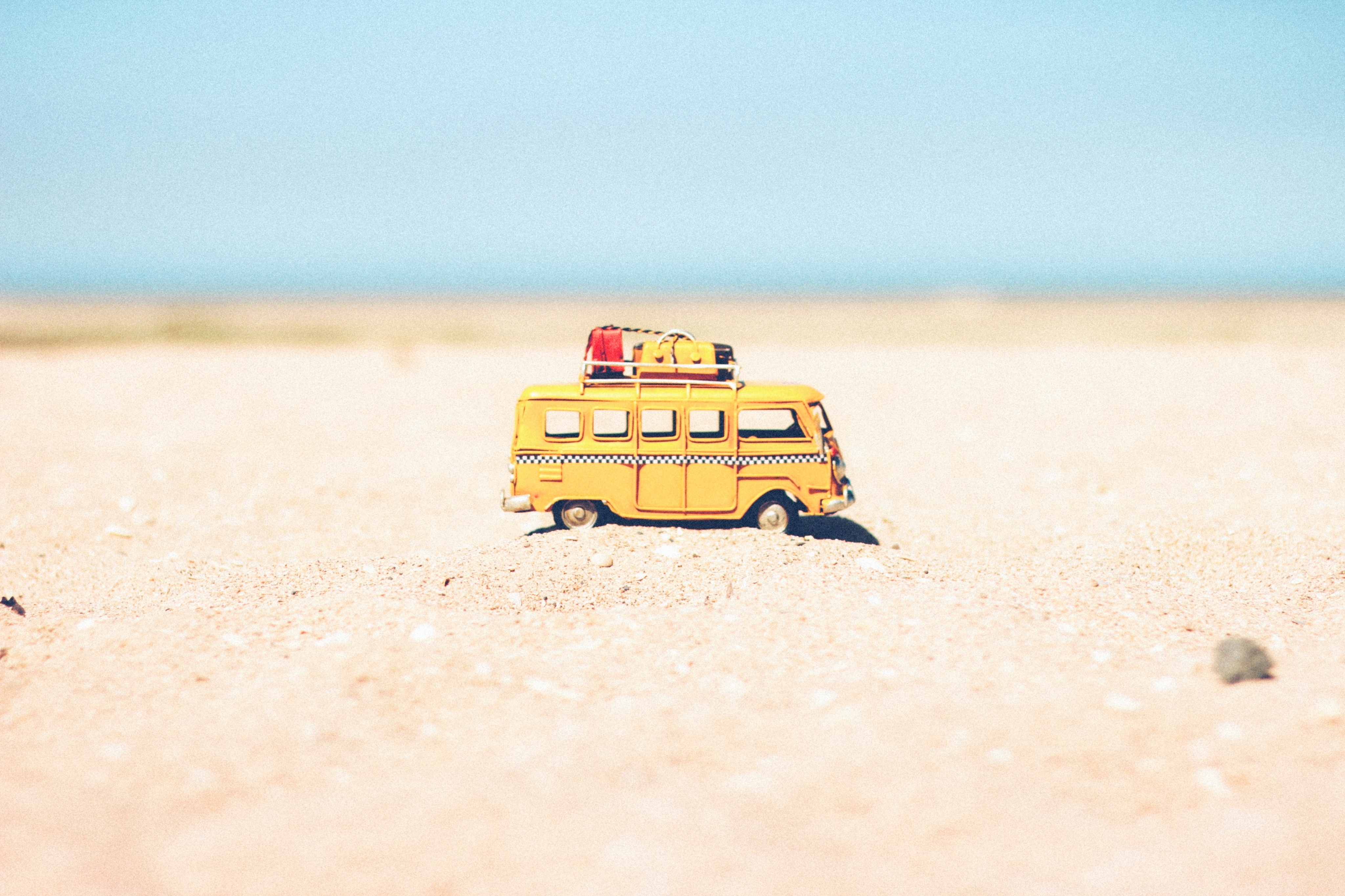 Toy yellow van on sand